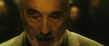 Movie still from “Crimson Rivers 2: Angels of the Apocalypse” (2004), directed by Olivier Dahan – An older man with a beard and mustache; Close Up shot, Over the shoulder angle