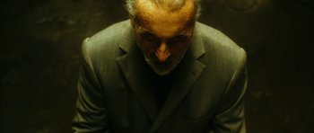 Movie still from “Crimson Rivers 2: Angels of the Apocalypse” (2004), directed by Olivier Dahan – An older man in a gray suit looking down at his face; Close Up shot, Overhead angle