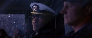Movie still from “Crimson Tide” (1995), directed by Tony Scott – A person wearing a uniform; Close Up shot, Over the shoulder angle