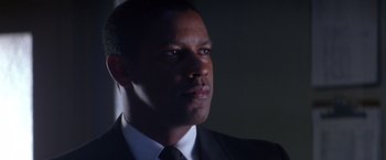 Movie still from “Crimson Tide” (1995), directed by Tony Scott – A person wearing a suit and tie; Close Up shot, Low angle