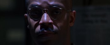 Movie still from “Crimson Tide” (1995), directed by Tony Scott – A person wearing glasses and a mustache; Close Up shot, Low angle