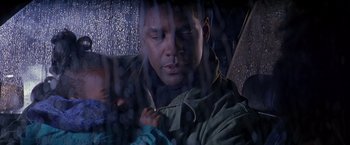 Movie still from “Crimson Tide” (1995), directed by Tony Scott – A man sitting in the back of a car looking out the window; Close Up shot, Low angle