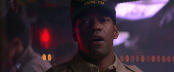 Movie still from “Crimson Tide” (1995), directed by Tony Scott – A person wearing a hat; Close Up shot, Low angle