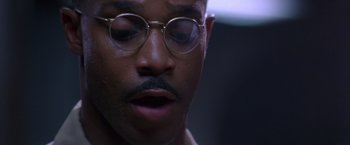 Movie still from “Crimson Tide” (1995), directed by Tony Scott – A person wearing glasses; Extreme Close Up shot, Low angle