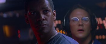 Movie still from “Crimson Tide” (1995), directed by Tony Scott – A person wearing headphones; Close Up shot, Low angle