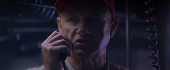 Movie still from “Crimson Tide” (1995), directed by Tony Scott – A person talking on a cell phone; Close Up shot, Low angle