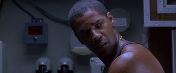 Movie still from “Crimson Tide” (1995), directed by Tony Scott – A person wearing a tank top; Close Up shot, Low angle