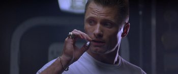 Movie still from “Crimson Tide” (1995), directed by Tony Scott – A person talking on a cell phone; Close Up shot, Low angle