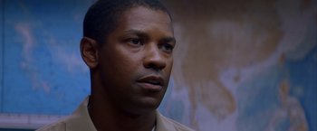 Movie still from “Crimson Tide” (1995), directed by Tony Scott – A man in a tan shirt is looking to his left; Close Up shot, Low angle