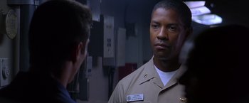 Movie still from “Crimson Tide” (1995), directed by Tony Scott – A man in a uniform talking to another man in a uniform; Close Up shot, Over the shoulder angle