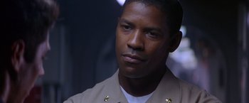 Movie still from “Crimson Tide” (1995), directed by Tony Scott – A person wearing a uniform; Close Up shot, Over the shoulder angle