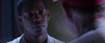 Movie still from “Crimson Tide” (1995), directed by Tony Scott – A person looking at a mirror; Close Up shot, Over the shoulder angle