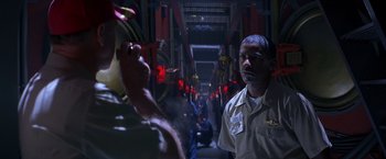 Movie still from “Crimson Tide” (1995), directed by Tony Scott – A man standing next to an animal in a room; Close Up shot, Low angle