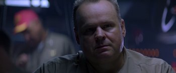 Movie still from “Crimson Tide” (1995), directed by Tony Scott – A person wearing a shirt; Close Up shot, Over the shoulder angle