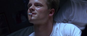 Movie still from “Crimson Tide” (1995), directed by Tony Scott – A man with a cigarette in his mouth; Close Up shot, Low angle