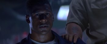 Movie still from “Crimson Tide” (1995), directed by Tony Scott – A person with a hand on his shoulder; Close Up shot, Low angle