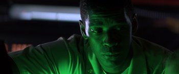 Movie still from “Crimson Tide” (1995), directed by Tony Scott – A man's face in a dark room; Close Up shot, Low angle