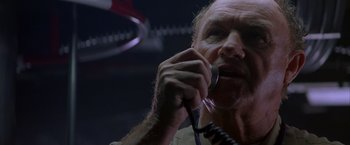 Movie still from “Crimson Tide” (1995), directed by Tony Scott – An older man is holding a phone cord; Close Up shot, Low angle
