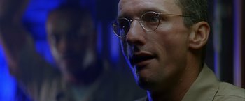 Movie still from “Crimson Tide” (1995), directed by Tony Scott – A person wearing glasses; Close Up shot, Low angle