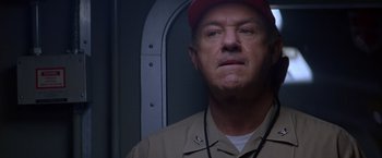 Movie still from “Crimson Tide” (1995), directed by Tony Scott – A person wearing a hat; Close Up shot, Low angle