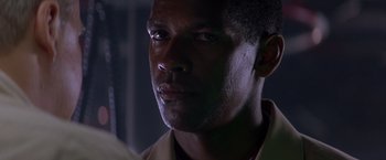 Movie still from “Crimson Tide” (1995), directed by Tony Scott – A man's face in the dark; Close Up shot, Low angle