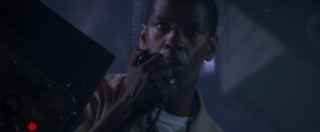 Movie still from “Crimson Tide” (1995), directed by Tony Scott – A person holding a cell phone; Close Up shot, Low angle