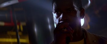 Movie still from “Crimson Tide” (1995), directed by Tony Scott – A person smoking a cigarette; Close Up shot, Low angle