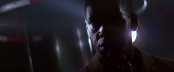 Movie still from “Crimson Tide” (1995), directed by Tony Scott – A man's face in the dark; Close Up shot, Low angle