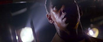 Movie still from “Crimson Tide” (1995), directed by Tony Scott – A man's face in the dark; Close Up shot, Low angle