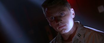 Movie still from “Crimson Tide” (1995), directed by Tony Scott – A person wearing a white shirt; Close Up shot, Low angle