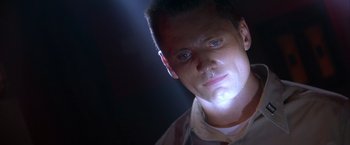 Movie still from “Crimson Tide” (1995), directed by Tony Scott – A person with a light shining on his face; Close Up shot, Low angle