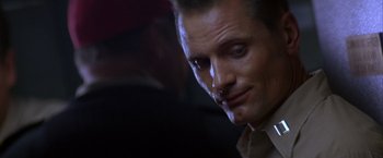 Movie still from “Crimson Tide” (1995), directed by Tony Scott – A person wearing a suit and tie; Close Up shot, Over the shoulder angle