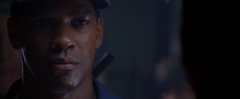 Movie still from “Crimson Tide” (1995), directed by Tony Scott – A person wearing a hat; Close Up shot, Over the shoulder angle