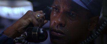 Movie still from “Crimson Tide” (1995), directed by Tony Scott – A person holding a hair dryer; Close Up shot, Low angle