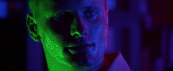 Movie still from “Crimson Tide” (1995), directed by Tony Scott – A person wearing a white shirt; Close Up shot, Low angle