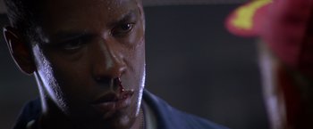 Movie still from “Crimson Tide” (1995), directed by Tony Scott – A man with blood on his face; Close Up shot, Low angle