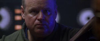 Movie still from “Crimson Tide” (1995), directed by Tony Scott – A person looking at the camera; Close Up shot, Low angle