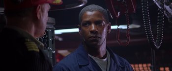 Movie still from “Crimson Tide” (1995), directed by Tony Scott – A person wearing a blue jacket; Close Up shot, Low angle