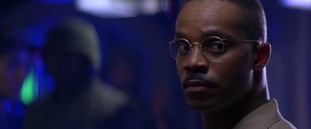 Movie still from “Crimson Tide” (1995), directed by Tony Scott – A person wearing glasses; Close Up shot, Over the shoulder angle