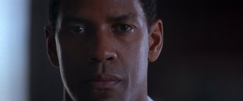 Movie still from “Crimson Tide” (1995), directed by Tony Scott – A man's face in the dark; Close Up shot, Low angle