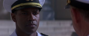Movie still from “Crimson Tide” (1995), directed by Tony Scott – A person wearing a uniform; Close Up shot, Low angle