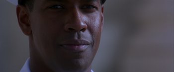 Movie still from “Crimson Tide” (1995), directed by Tony Scott – A man's face in a dark room; Close Up shot, Low angle