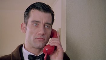 Movie still from “Croupier” (1998), directed by Mike Hodges – A person talking on a phone; Close Up shot, Low angle