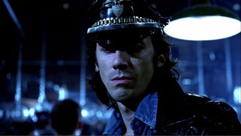 Movie still from “Cruising” (1980), directed by William Friedkin – A person wearing a helmet; Close Up shot, Low angle