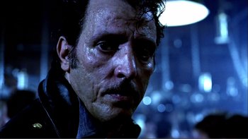 Movie still from “Cruising” (1980), directed by William Friedkin – A man's face in the dark; Close Up shot, Low angle