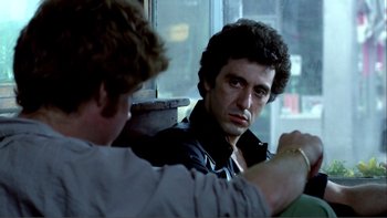 Movie still from “Cruising” (1980), directed by William Friedkin – A man sitting in front of a mirror looking at himself in the mirror; Close Up shot, Over the shoulder angle