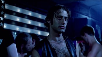Movie still from “Cruising” (1980), directed by William Friedkin – A person wearing a leather vest; Close Up shot, Low angle