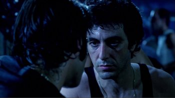 Movie still from “Cruising” (1980), directed by William Friedkin – A person looking at another person; Close Up shot, Over the shoulder angle