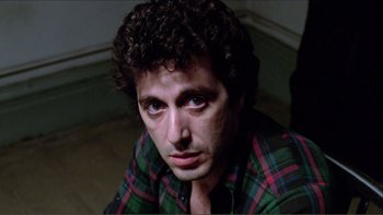 Movie still from “Cruising” (1980), directed by William Friedkin – A person wearing a plaid shirt; Close Up shot, Low angle