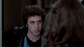 Movie still from “Cruising” (1980), directed by William Friedkin – A person wearing a leather jacket; Close Up shot, Over the shoulder angle